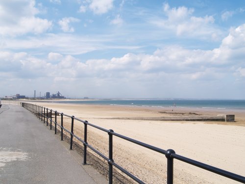 Looking up the coast from Redcar beach, towards the steelworks and South Gare at mouth of the River Tees.