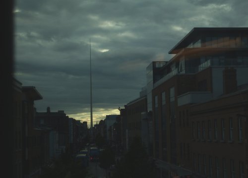 The very striking outline of the Spire of Dublin, viewed at dusk from the DART train.