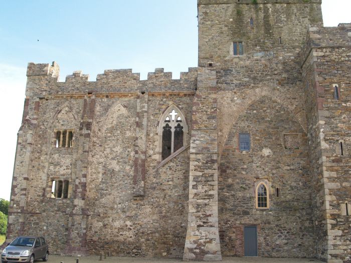 The exterior north walls of the chancel and tower. The pointed arch would have been where the north transept was Tintern Abbey, Wexford, Ireland