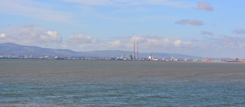Looking across Dublin Bay from Sutton to the chimneys of the old power station Howth to Sutton Cliff Walk, Co. Dublin, Ireland