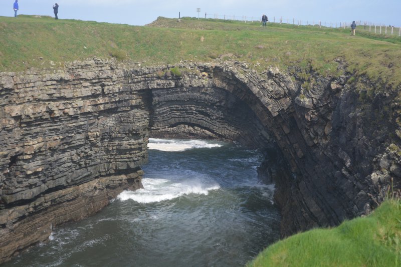 Of the original three, the last remaining natural sea arch of the Bridges of Ross, note the anticline layers of rocks Bridges of Ross walk, Loop Head Peninsula, Co Clare, West of Ireland