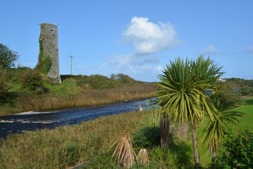 The ruins of the tower house, all that is left of Doonbeg Castle on the banks of the Doonbeg River (Abhainn an Duin Bhig) Doonbeg, Co. Clare, West Atlantic Coast of Ireland