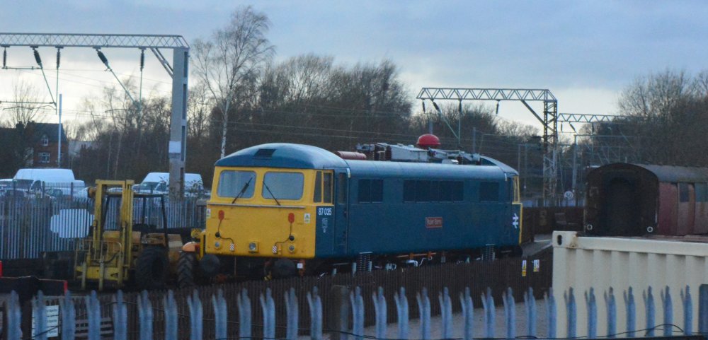 In the yard of the LNWR Heritage Co. Ltd. is Class 87 electric locomotive 87035 Robert Burns in BR blue livery (Crewe Heritage Centre, March 2020) In the yard of the LNWR Heritage Co. Ltd. is Class 87 electric locomotive 87035 Robert Burns in BR blue livery (Crewe Heritage Centre, March 2020)