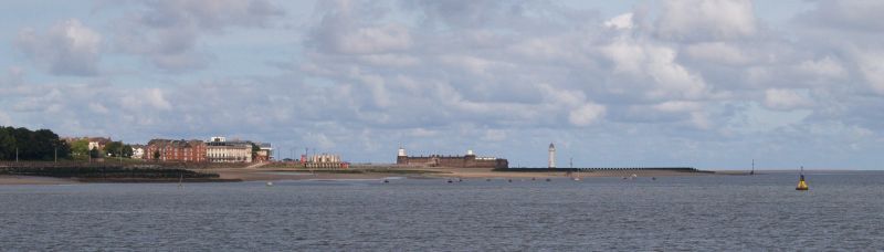 River Mersey Ferry Trip Scenes New Brighton beach and the old fort the Perch Rock Battery across the water from the port of Liverpool
