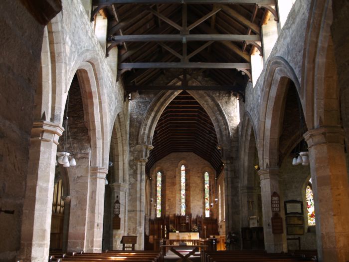 Looking eastwards down the nave to the great chancel arch (12th century) and alter. The nave and aisles show the basic shape and size of the church derived from the building work of the 13th century.