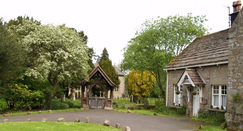 The centre of the tiny village of Beltingham, in the centre the Lych Gate entrance to St Cuthbert's Church.