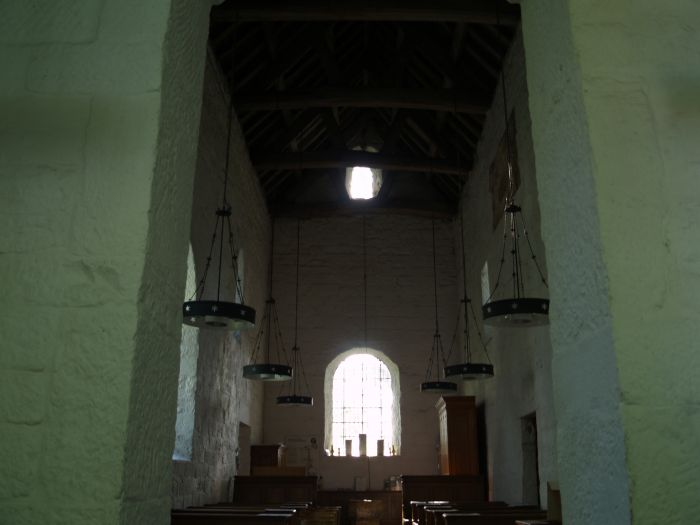 Looking towards the font and west end. There was considerable reuse of Roman masonry in its original construction about AD 675.