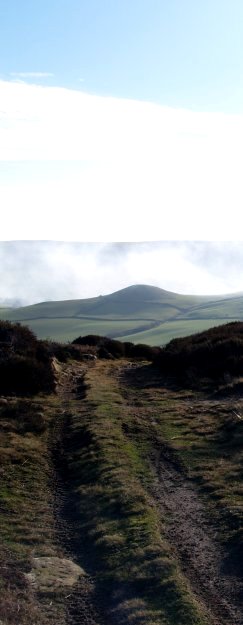 Looking down from Danby Rigg into Fryup Dale with Fairy Cross Plain shrouded in smoke from heather burning. On the skyline is Glaisdale Rigg.