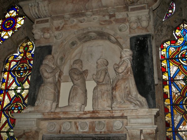 The 1611 alabaster monument to Sir John Acclom and his wife sits rather nicely between two of the stained glass windows St Helen's Church Stillinfleet