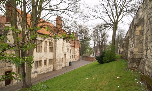 The buildings of the King's Manor with the City Walls on the right.