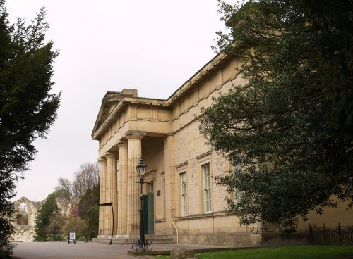 The entrance to the Museum, with the ruins of St Mary's Abbey in the distance. The building, dating from 1827, is built in the neo-classical style and houses collections of archaeology (prehistoric-Roman-Viking etc.), natural history, geology and pottery from all over Yorkshire.