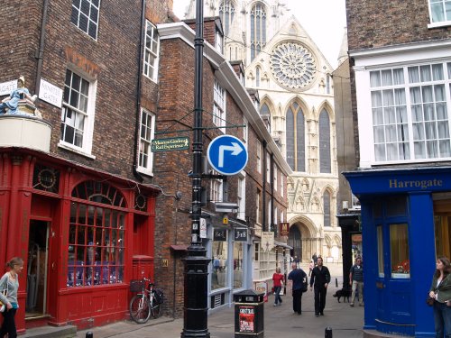 The cross-roads where High Petergate meets Low Petergate with the Rose window of the Minster in the background.
