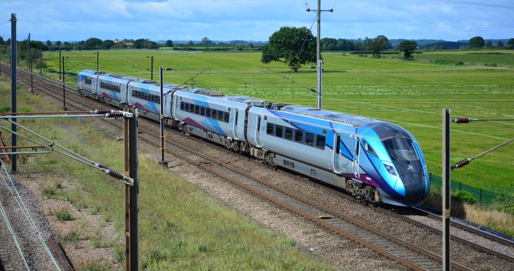 Class 802 bi-mode 802213 with the TransPennine 0754 service from Liverpool Lime Street to Newcastle trainspotting Colton Junction footbridge