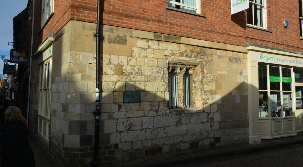 A medieval window survives on the lower floor of a once medieval building in Shambles Market, York