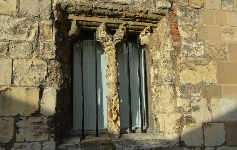 Details of the heavily weathered and eroded medieval window.