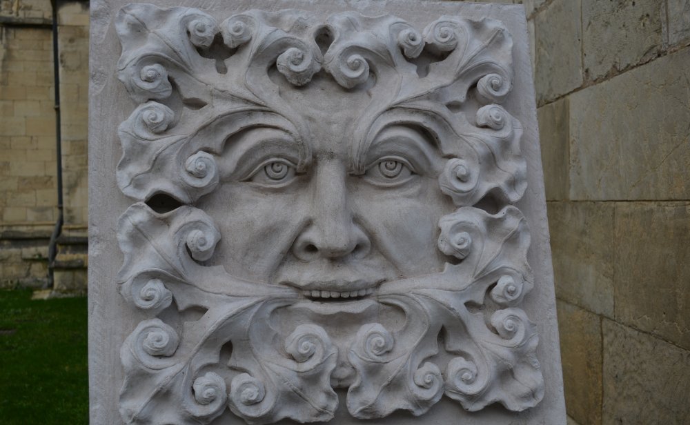 York Minster Green Man carving in Minster Yard, it also functions as visual attraction to the donation box for York Minster