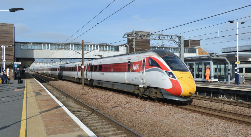 The rear of Class 800 800110 LNER/Azuma service from Kings Cross, London, to Inverness heading north through Peterborough Station (February 2023)